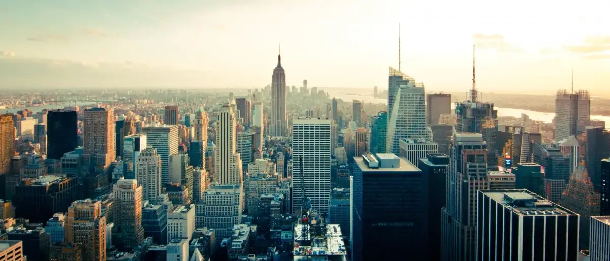 A city skyline of office towers photographed from above at dusk